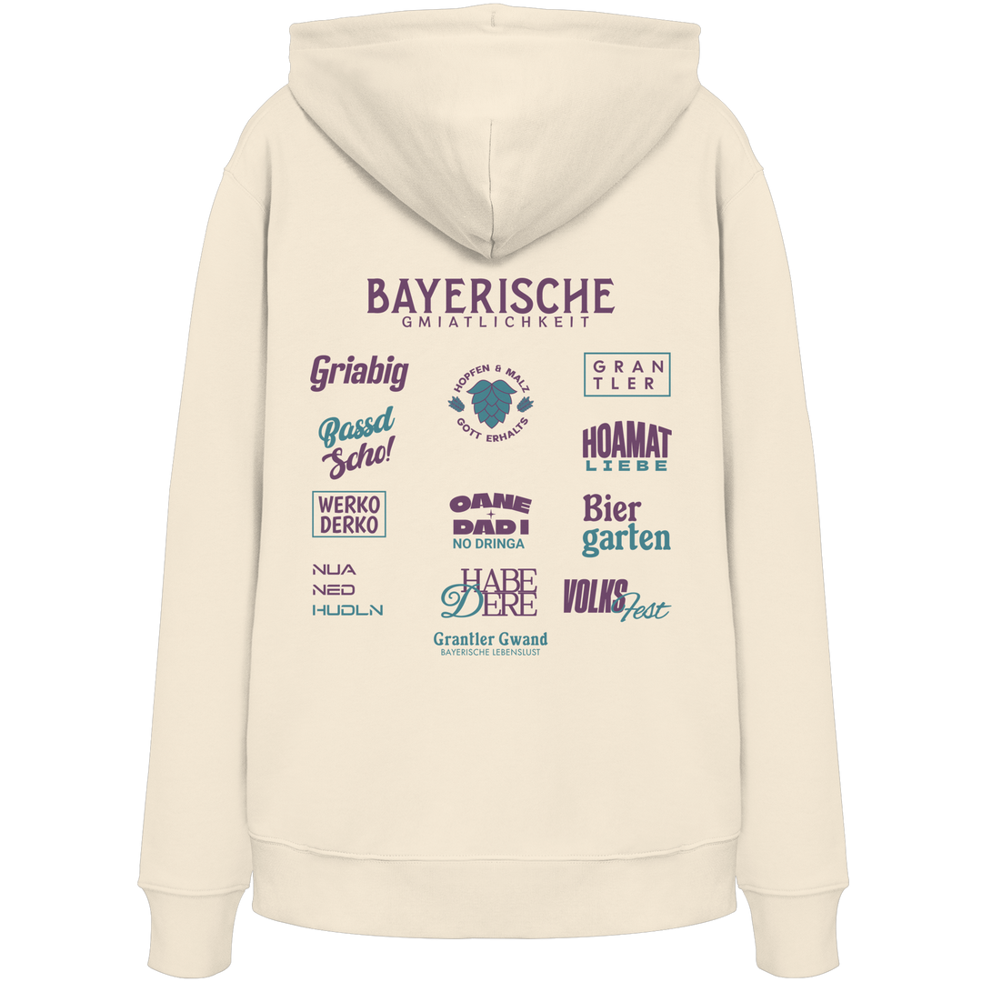 Beiger Unisex Hoodie mit großem lila Backprint „Bayerische Gmiatlichkeit“ und bayerischen Begriffen wie Hoamatliebe, Biergarten, Volksfest, Grantler, Hopfen &amp; Malz und Griabig. Unisex Premium-Hoodie mit Kapuze im modernen Streetwear-Style. Designed und bedruckt in Bayern von Grantler Gwand.