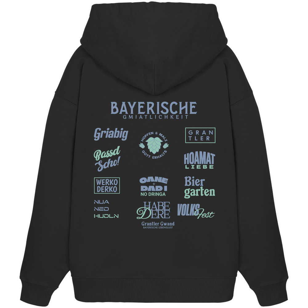 Schwarzer Bayerische Gmiatlichkeit Oversize Hoodie mit großem grünem Backprint und bayerischen Symbolen. Unisex Premium-Hoodie aus Bio-Baumwolle im modernen Streetwear-Look für Biergarten, Volksfest und Freizeit. Designed und bedruckt in Bayern von Grantler Gwand.