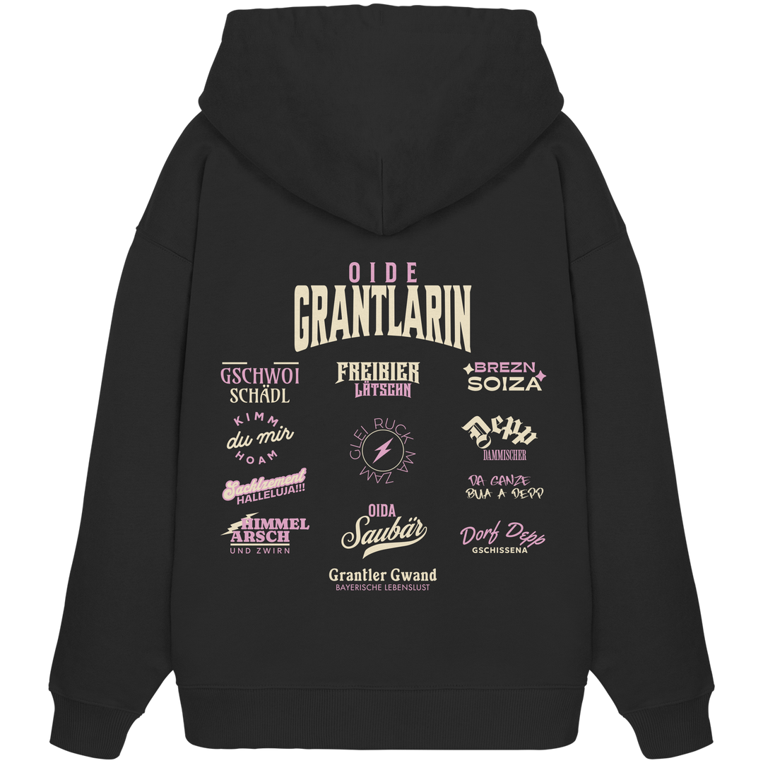 Schwarzer Oversize Hoodie mit großem Backprint „Oide Grantlarin“ und verschiedenen bayerischen Dialektbegriffen wie Gschwoi Schädl, Freibier Låtschn, Brezn Soiza, Oida Saubär und Dorf Depp von Grantler Gwand.