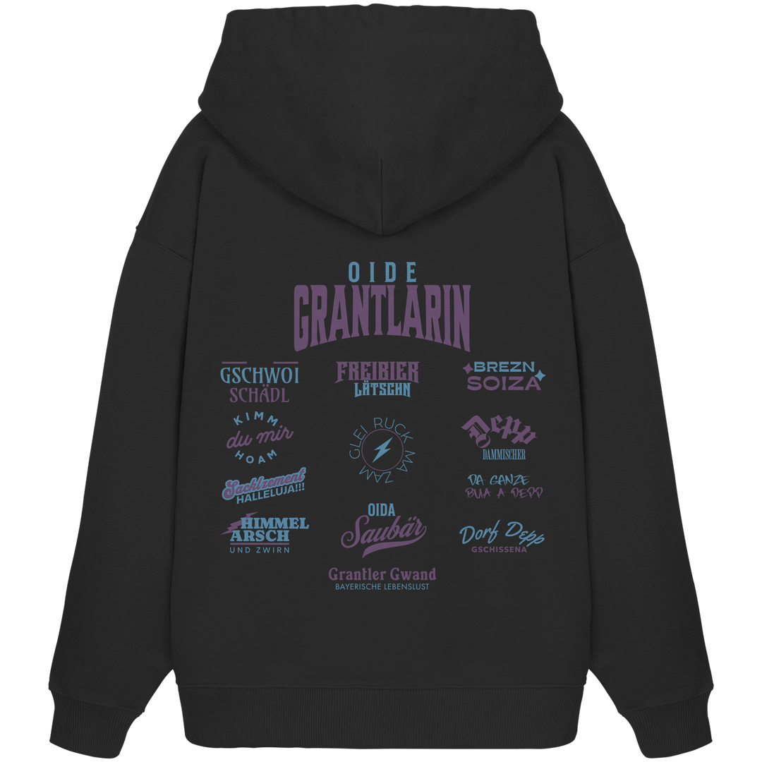 Schwarzer Oversize Hoodie mit großem Backprint „Oide Grantlarin“ und verschiedenen bayerischen Dialektbegriffen wie Gschwoi Schädl, Freibier Låtschn, Brezn Soiza, Oida Saubär und Dorf Depp von Grantler Gwand.