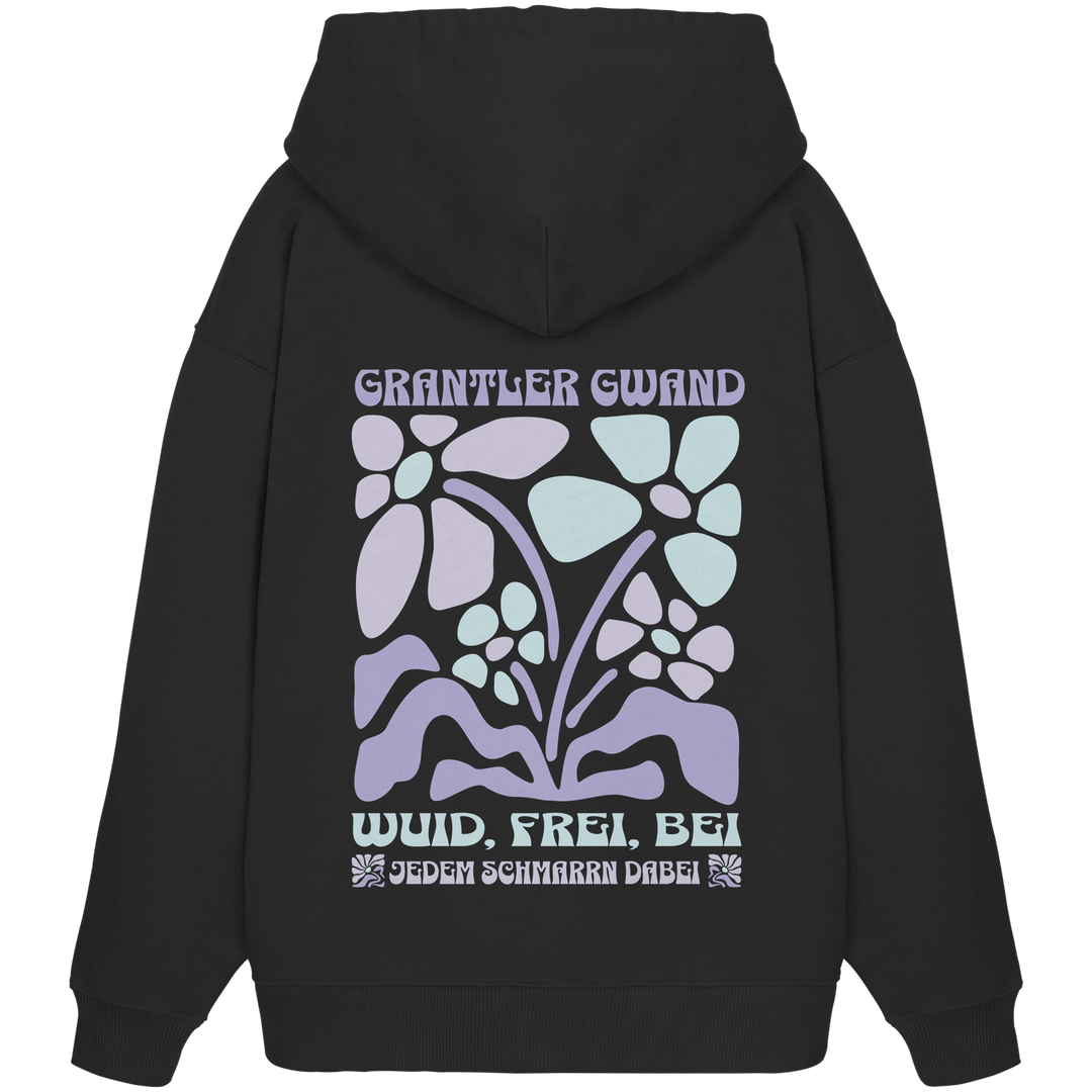 Schwarzer Oversize Hoodie mit großem Retro-Blumen-Backprint und dem bayerischen Schriftzug „Wuid, Frei, Bei Jedem Schmarrn Dabei“ von Grantler Gwand.