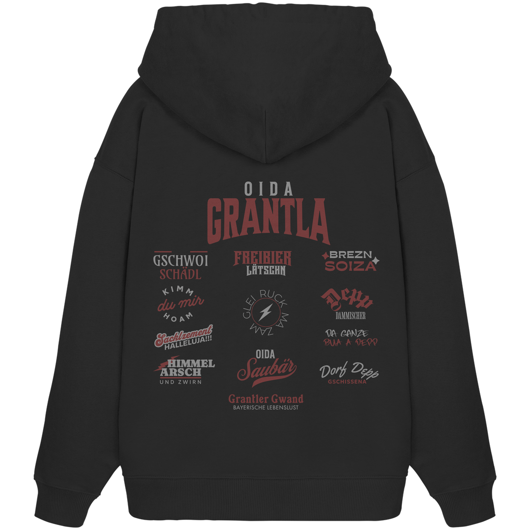 Schwarzer Oversize Hoodie mit großem Backprint „Oida Grantla“ und verschiedenen bayerischen Dialektbegriffen wie Gschwoi Schädl, Freibier Låtschn, Brezn Soiza, Oida Saubär und Dorf Depp von Grantler Gwand.
