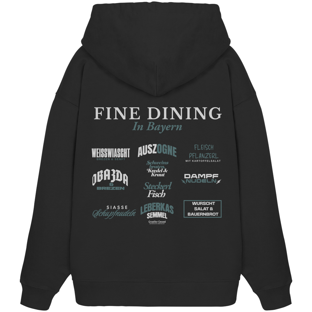 Schwarzer Oversize Hoodie mit großem Backprint "Fine Dining in Bayern" und verschiedenen bayerischen Spezialitäten wie Weißwiascht, Obazda, Auszogne, Steckerlfisch und Leberkas von Grantler Gwand.
