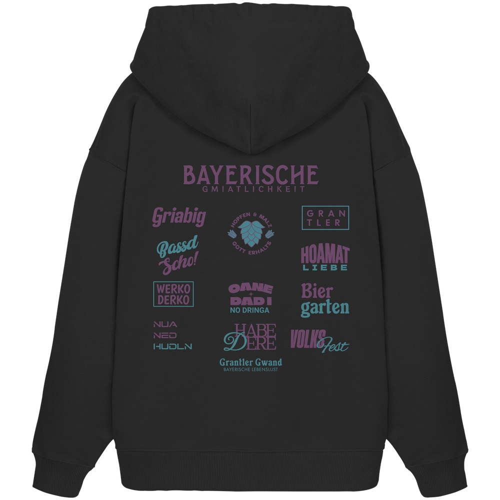 Schwarzer Oversize Hoodie mit großem lila Backprint „Bayerische Gmiatlichkeit“ und bayerischen Begriffen wie Hoamatliebe, Biergarten, Volksfest, Grantler, Hopfen & Malz und Griabig. Unisex Premium-Hoodie aus Bio-Baumwolle im modernen Streetwear-Style. Designed und bedruckt in Bayern von Grantler Gwand.
