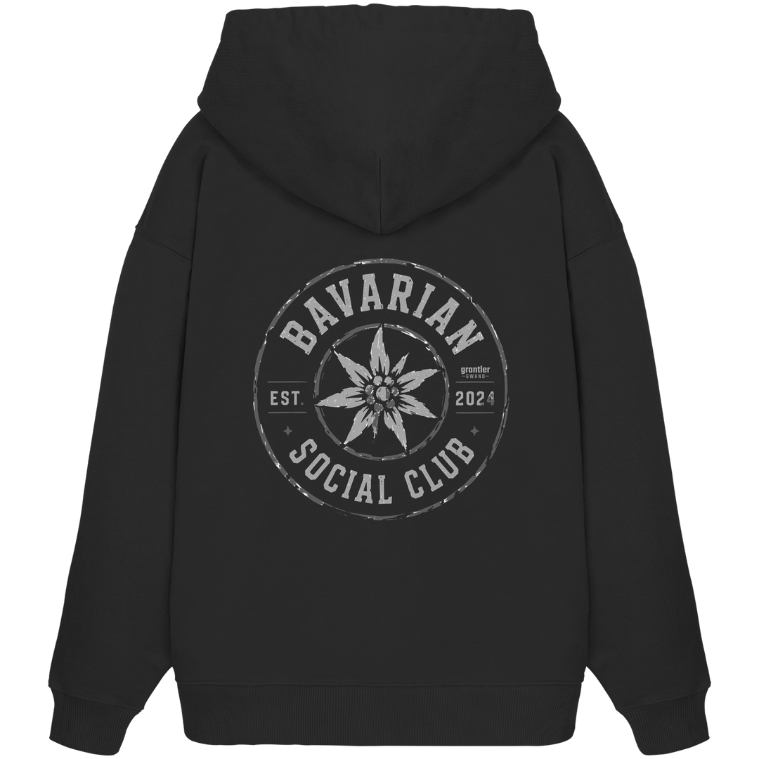Schwarzer Oversize Hoodie mit großem grauen Rundlogo „Bavarian Social Club“, Edelweiß-Motiv und Vintage-Backprint im Streetwear-Stil.