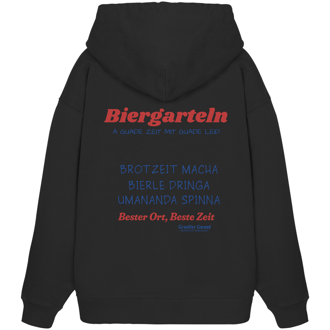 Schwarzer Oversize Hoodie mit großem Biergarteln Backprint in Rot und Blau sowie bayerischem Statement „A guade Zeit mit guade Leid“ – extra schwerer Premium Hoodie für Biergarten, Volksfest und moderne bayerische Streetwear von Grantler Gwand.