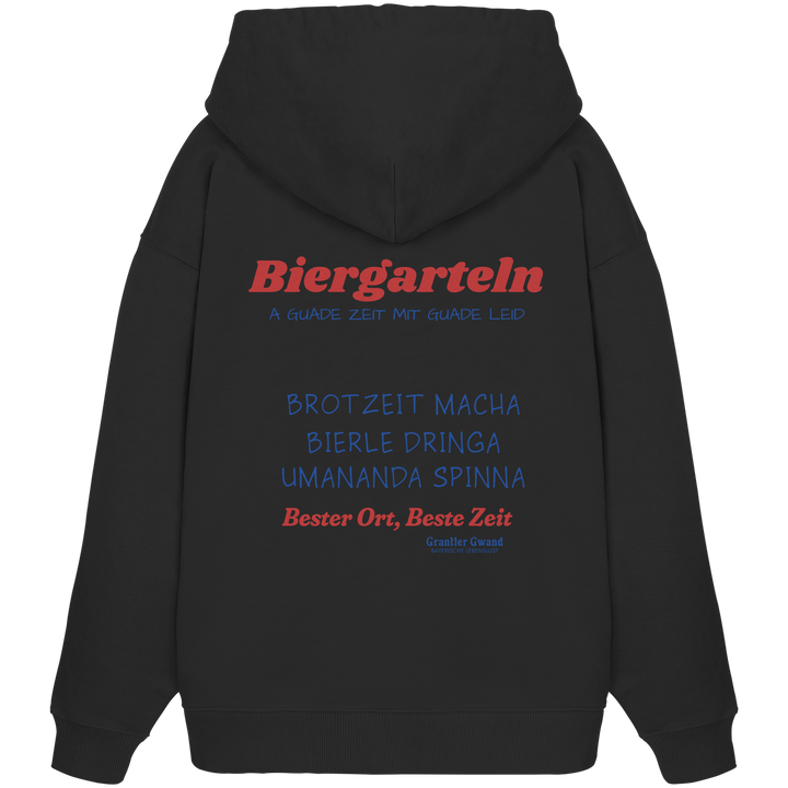 Schwarzer Oversize Hoodie mit großem Biergarteln Backprint in Rot und Blau sowie bayerischem Statement „A guade Zeit mit guade Leid“ – extra schwerer Premium Hoodie für Biergarten, Volksfest und moderne bayerische Streetwear von Grantler Gwand.