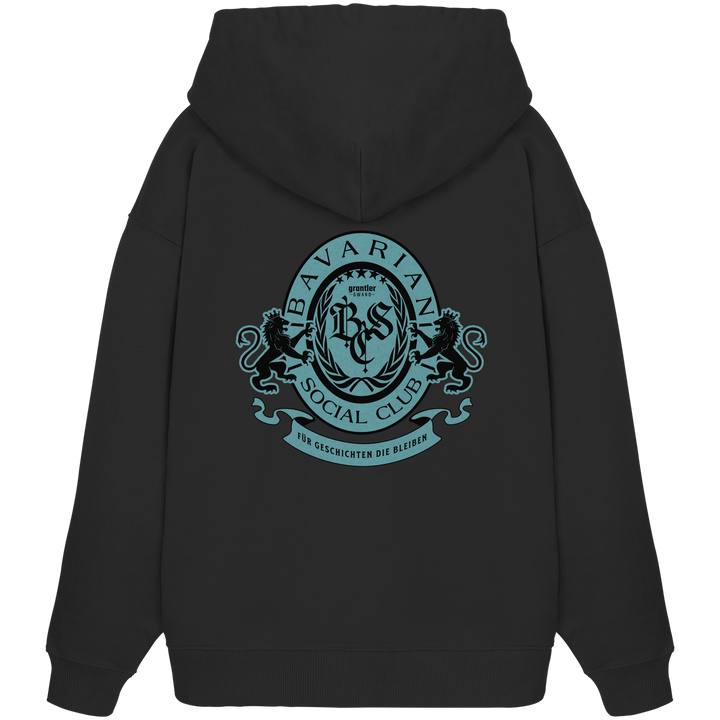 schwarzer Oversize Hoodie mit großem mintfarben-schwarzem Bavarian Social Club Wappen auf dem Rücken, verziert mit Lorbeerkranz, Löwen und dem Schriftzug „Für Geschichten die bleiben“.