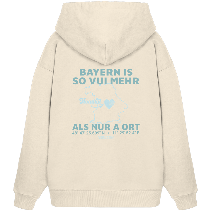 Cremefarbener Oversize Hoodie in schwerer Qualität von Grantler Gwand mit grünem Backprint „Bayern im Herzen“ und Bayern-Silhouette – bayerischer Streetwear Hoodie im Oversize-Schnitt.