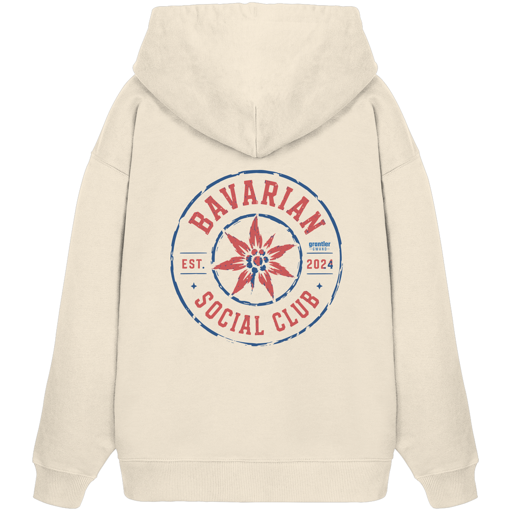 Naturfarbener Oversize Hoodie mit großem roten und blauen „Bavarian Social Club“-Backprint sowie Edelweiß-Motiv im Vintage-Streetwear-Design.