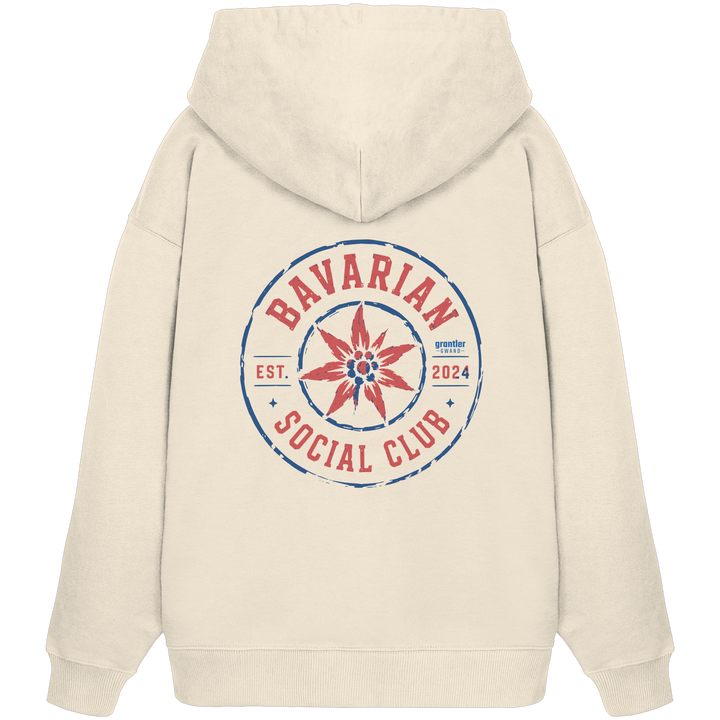 Naturfarbener Oversize Hoodie mit großem roten und blauen „Bavarian Social Club“-Backprint sowie Edelweiß-Motiv im Vintage-Streetwear-Design.