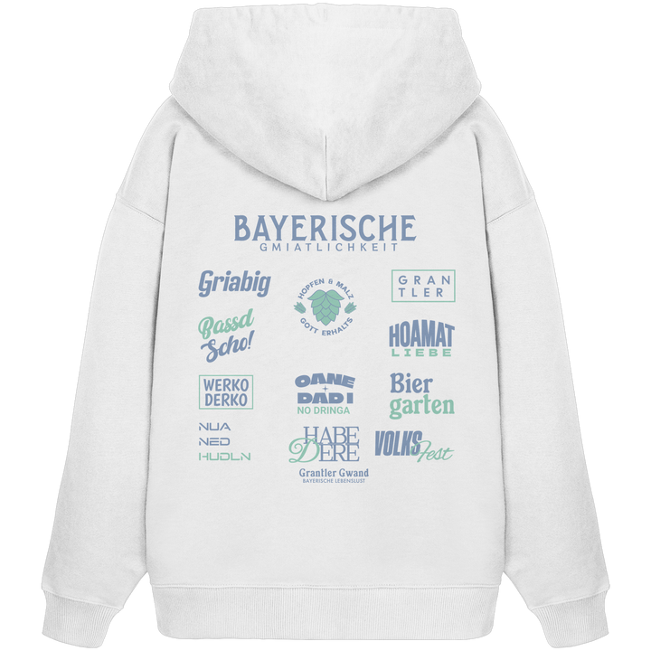 Weißer Bayerische Gmiatlichkeit Oversize Hoodie mit großem grünem Backprint und bayerischen Symbolen. Unisex Premium-Hoodie aus Bio-Baumwolle im modernen Streetwear-Look für Biergarten, Volksfest und Freizeit. Designed und bedruckt in Bayern von Grantler Gwand.