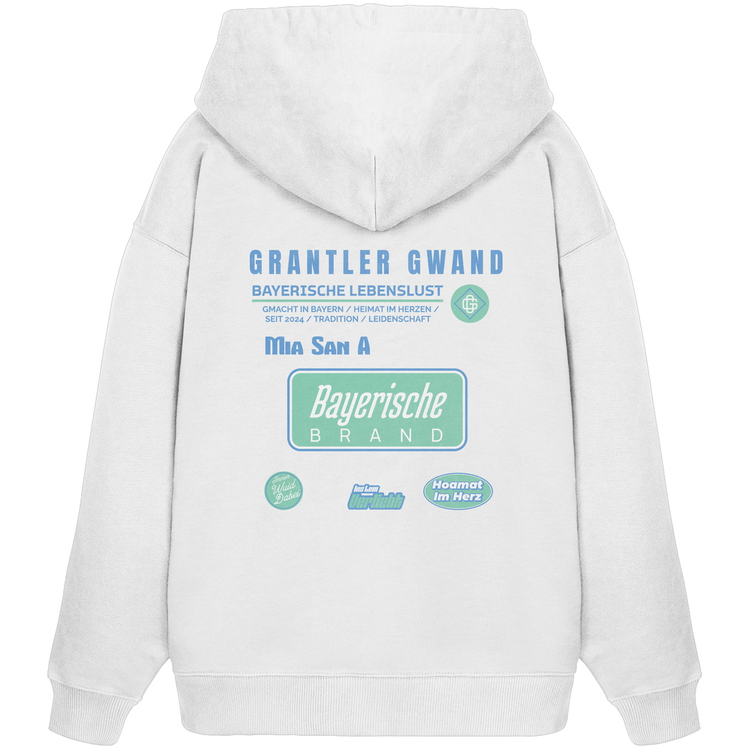 Weißer Oversize Hoodie mit großem Grantler Gwand Backprint, blau-grünem „Bayerische Brand“-Schriftzug und moderner bayerischer Streetwear-Grafik.