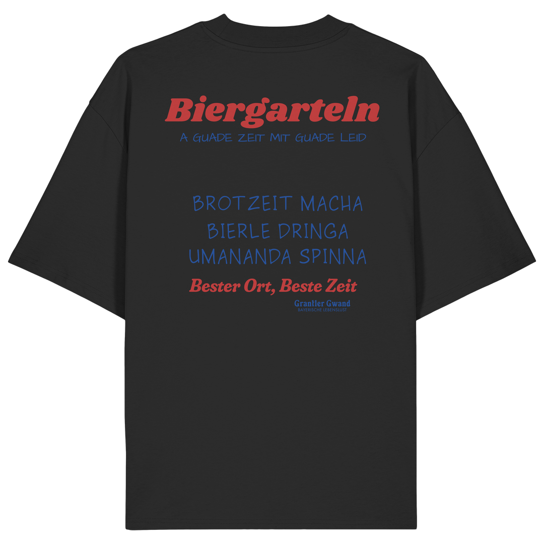 Schwarzes Oversize Unisex T-Shirt mit großem Biergarteln Backprint in Rot und bayerischem Statement „A guade Zeit mit guade Leid“. Schweres Premium-Shirt für Biergarten, Volksfest, Stammtisch und moderne bayerische Streetwear. Designed und bedruckt in Bayern von Grantler Gwand.