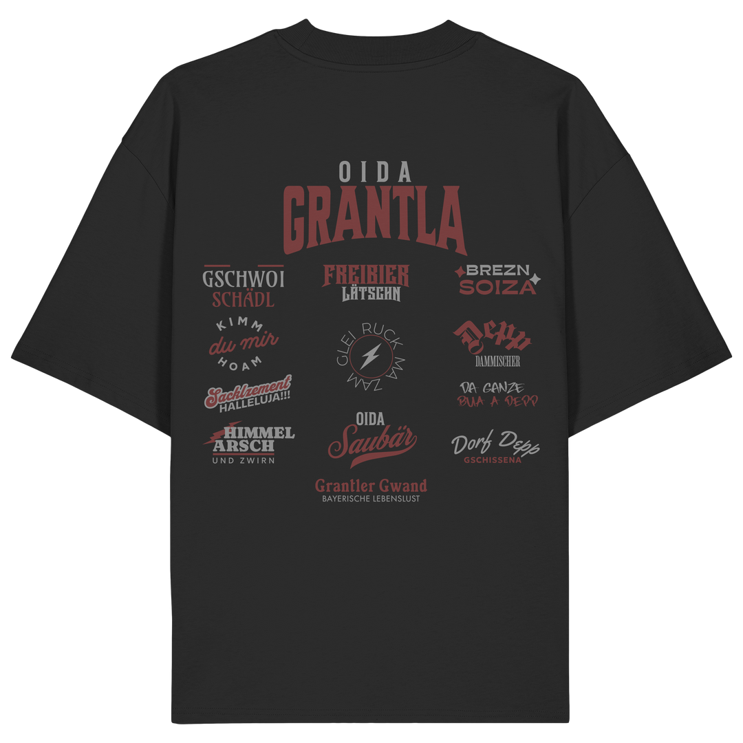 Schwarzes Oversize Shirt mit großem Backprint „Oida Grantla“ und verschiedenen bayerischen Dialektbegriffen wie Gschwoi Schädl, Freibier Låtschn, Brezn Soiza, Oida Saubär und Dorf Depp von Grantler Gwand.