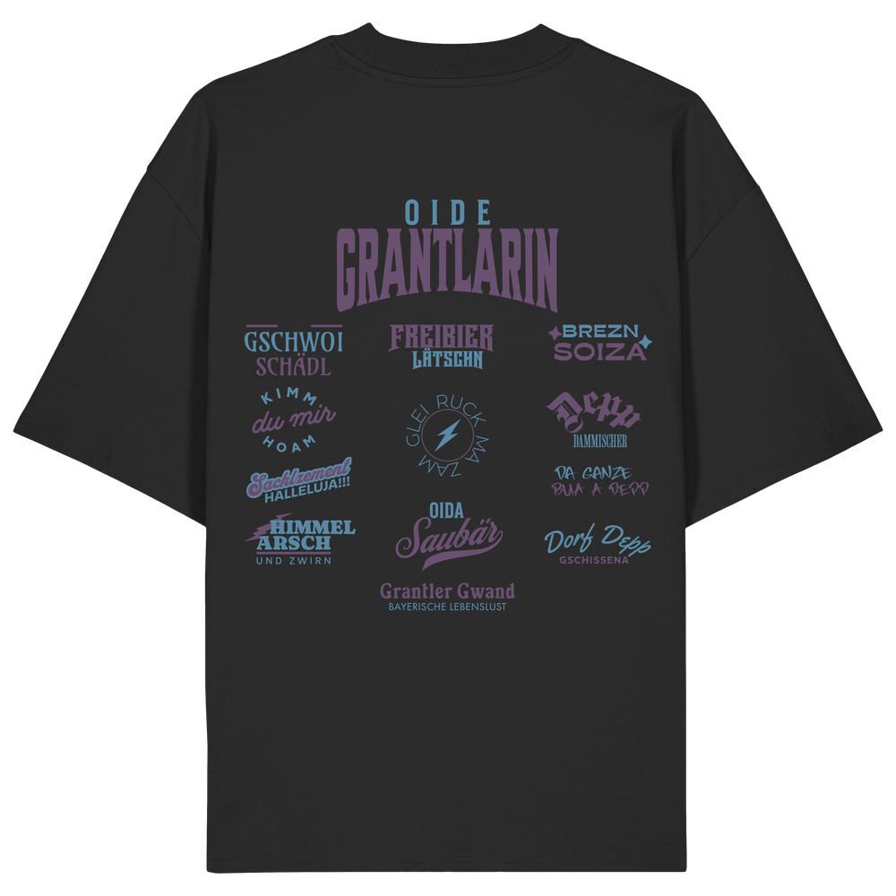 Schwarzes Oversize Shirt mit großem Backprint „Oide Grantlarin“ und verschiedenen bayerischen Dialektbegriffen wie Gschwoi Schädl, Freibier Låtschn, Brezn Soiza, Oida Saubär und Dorf Depp von Grantler Gwand.