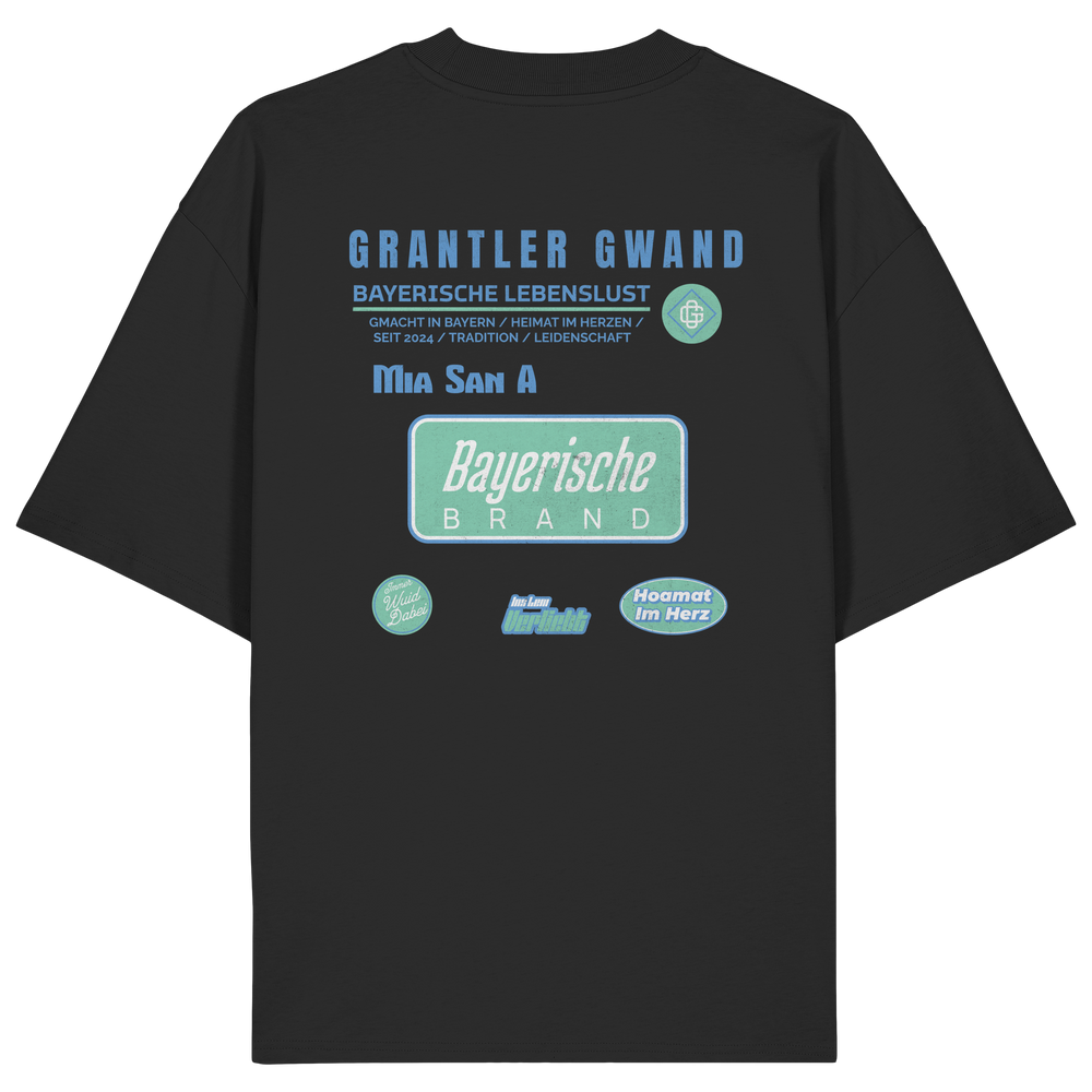 schwarzes Oversize T-Shirt mit großem Grantler Gwand Backprint in Blau und Mintgrün sowie dem Schriftzug „Bayerische Brand“ im modernen Streetwear-Design.
