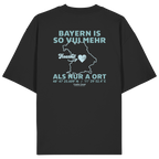 Schwarzes Oversize T-Shirt von Grantler Gwand mit grünem Backprint „Bayern is so vui mehr als nur a Ort“ und Bayern-Silhouette – bayerisches Streetwear Shirt aus Bio-Baumwolle.