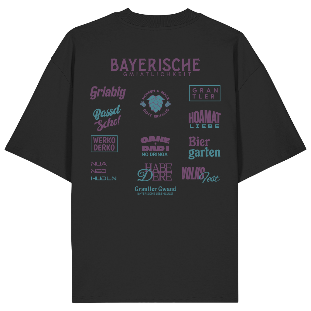 Schwarzes Oversize-Shirt mit großem lila Backprint „Bayerische Gmiatlichkeit“ und typischen bayerischen Begriffen wie Hoamatliebe, Biergarten, Volksfest, Grantler, Hopfen & Malz und Griabig. Unisex Premium-Shirt aus Bio-Baumwolle im modernen Streetwear-Style. Designed und bedruckt in Bayern von Grantler Gwand.