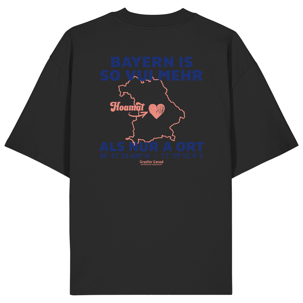 Schwarzes Oversize T-Shirt von Grantler Gwand mit blauem Backprint „Bayern is so vui mehr als nur a Ort“, Herzsymbol und Bayern-Silhouette – bayerisches Streetwear Shirt aus Bio-Baumwolle.