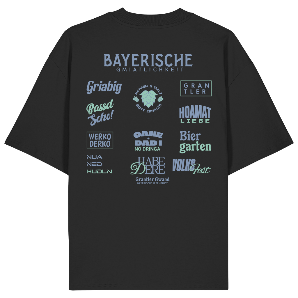Schwarzes Bayerische Gmiatlichkeit Oversize Shirt mit großem grünem Backprint und bayerischen Begriffen wie Hoamatliebe, Biergarten, Volksfest, Grantler, Hopfen & Malz und Griabig. Unisex Heavy Oversized T-Shirt aus Bio-Baumwolle im modernen Streetwear-Look. Designed und bedruckt in Bayern von Grantler Gwand.