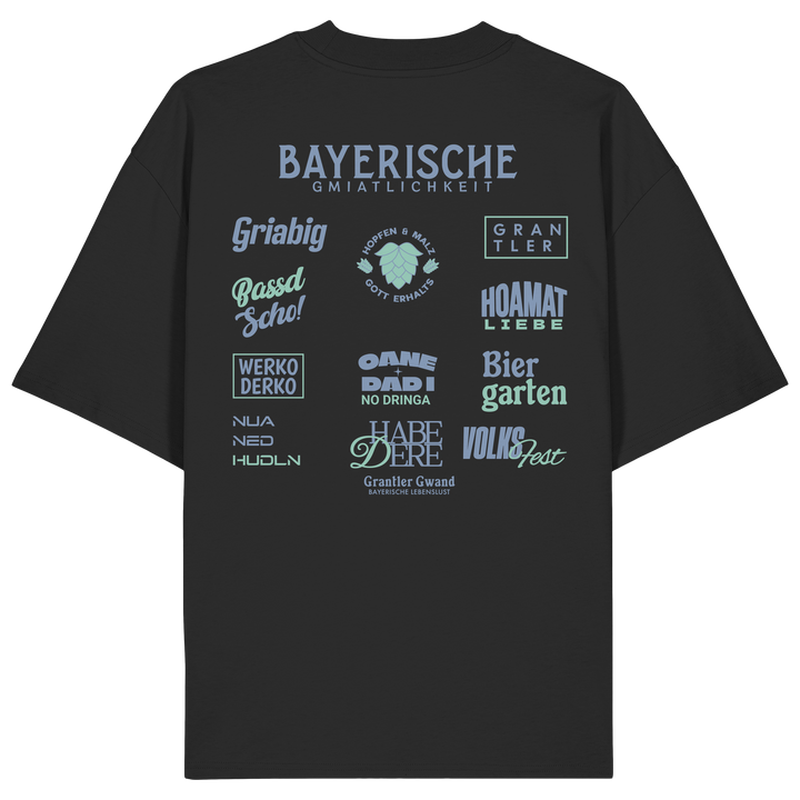 Schwarzes Bayerische Gmiatlichkeit Oversize Shirt mit großem grünem Backprint und bayerischen Begriffen wie Hoamatliebe, Biergarten, Volksfest, Grantler, Hopfen &amp; Malz und Griabig. Unisex Heavy Oversized T-Shirt aus Bio-Baumwolle im modernen Streetwear-Look. Designed und bedruckt in Bayern von Grantler Gwand.