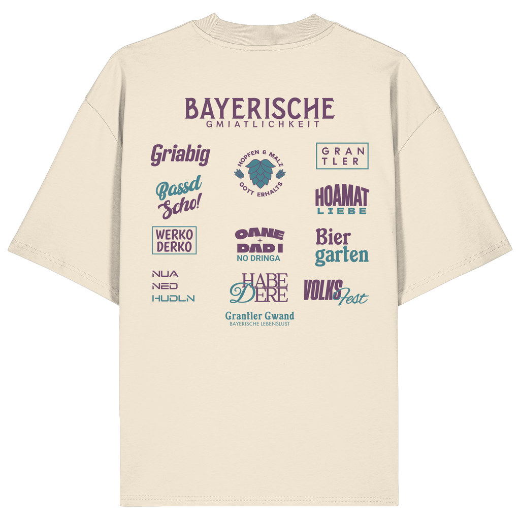 Beiges Oversize-Shirt mit großem lila Backprint „Bayerische Gmiatlichkeit“ und typischen bayerischen Begriffen wie Hoamatliebe, Biergarten, Volksfest, Grantler, Hopfen & Malz und Griabig. Unisex Premium-Shirt aus Bio-Baumwolle im modernen Streetwear-Style. Designed und bedruckt in Bayern von Grantler Gwand.