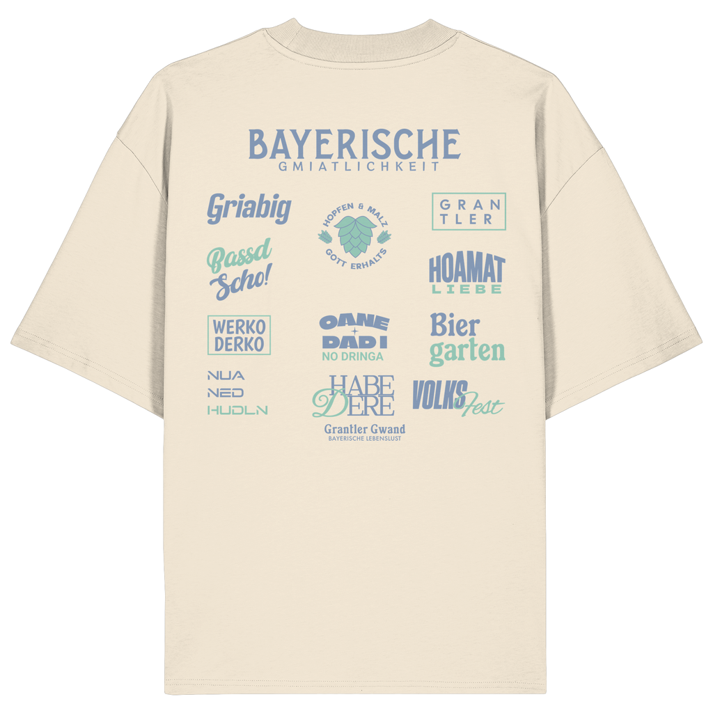 Beiges Bayerische Gmiatlichkeit Oversize Shirt mit großem grünem Backprint und bayerischen Begriffen wie Hoamatliebe, Biergarten, Volksfest, Grantler, Hopfen & Malz und Griabig. Unisex Heavy Oversized T-Shirt aus Bio-Baumwolle im modernen Streetwear-Look. Designed und bedruckt in Bayern von Grantler Gwand.
