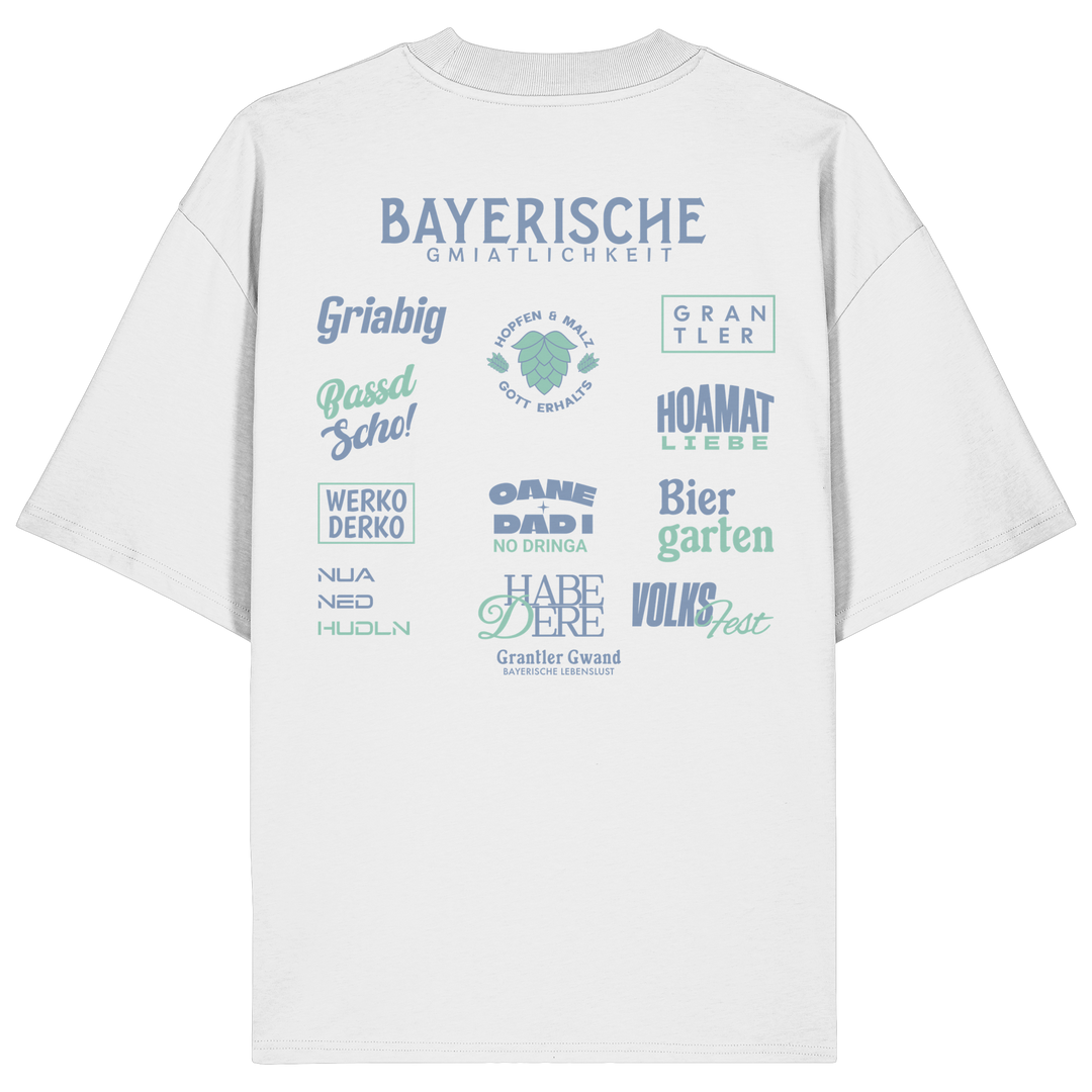 Weißes Bayerische Gmiatlichkeit Oversize Shirt mit großem grünem Backprint und bayerischen Begriffen wie Hoamatliebe, Biergarten, Volksfest, Grantler, Hopfen & Malz und Griabig. Unisex Heavy Oversized T-Shirt aus Bio-Baumwolle im modernen Streetwear-Look. Designed und bedruckt in Bayern von Grantler Gwand.