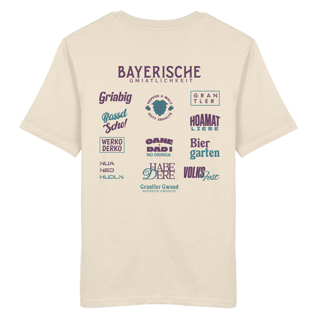 Beiges Unisex T-Shirt mit großem lila Backprint „Bayerische Gmiatlichkeit“ und typischen bayerischen Begriffen wie Hoamatliebe, Biergarten, Volksfest, Grantler, Hopfen &amp; Malz und Griabig. Unisex Premium-T-Shirt aus ringgesponnener Baumwolle im modernen Streetwear-Style. Designed und bedruckt in Bayern von Grantler Gwand.