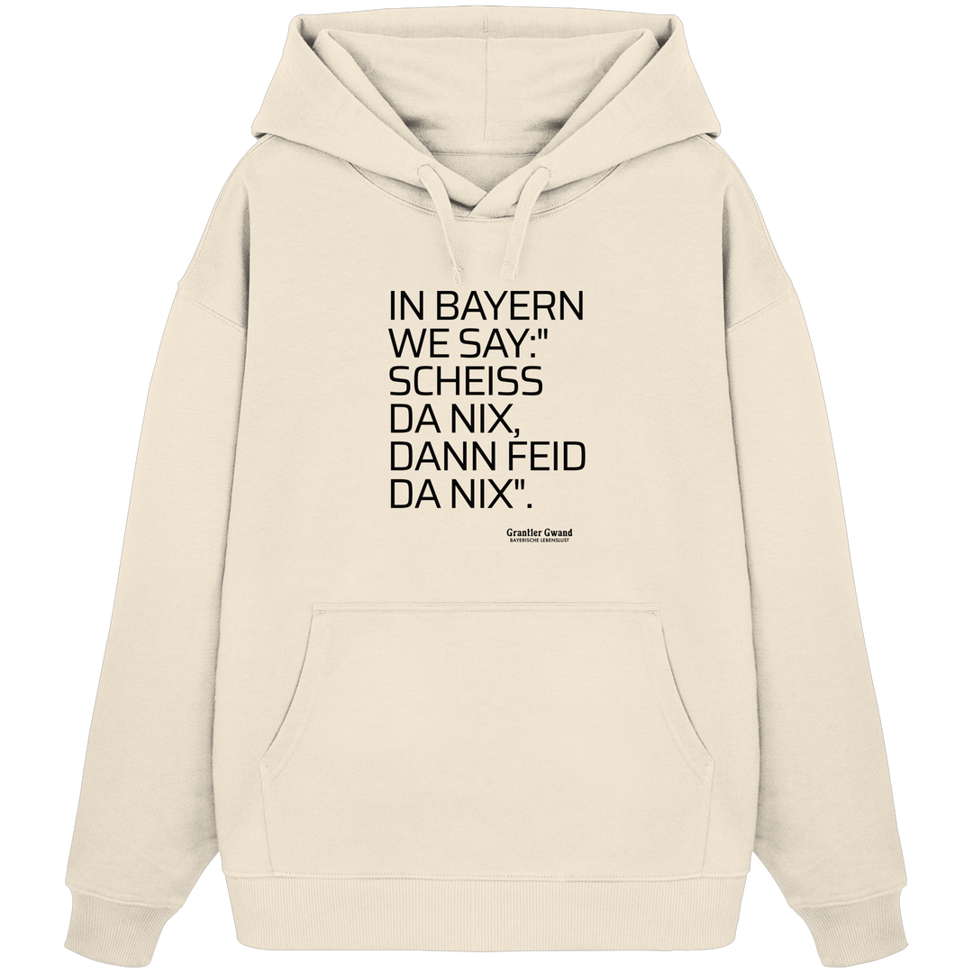 Naturfarbener Oversize Hoodie mit schwarzem Schriftzug "In Bayern we say: Scheiß da nix, dann feid da nix" im minimalistischen bayerischen Streetwear-Design von Grantler Gwand.