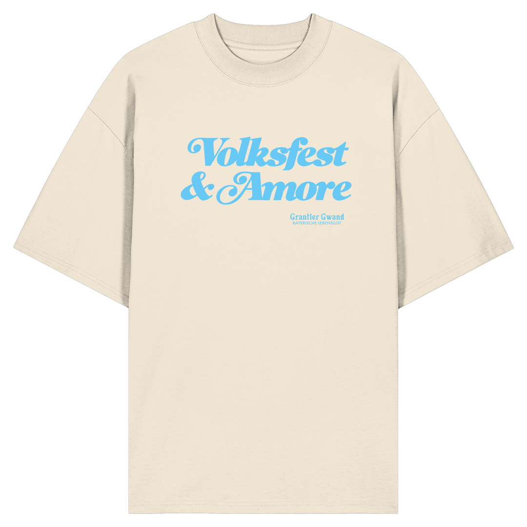 Beiges Oversize-T-Shirt mit blauem Frontprint „Volksfest &amp; Amore“. Modernes bayerisches Streetwear-Design für Volksfest, Biergarten und Freizeit. Hochwertiges Unisex Oversize-Shirt aus Bio-Baumwolle, designed und bedruckt in Bayern von Grantler Gwand.